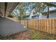 An exterior view of the backyard featuring a partial view of a fence and gray home at 716 Saint Matthew Cir, Altamonte Springs, FL 32714