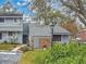 Exterior elevation of a charming gray home with a brick accent wall and well-maintained landscaping at 716 Saint Matthew Cir, Altamonte Springs, FL 32714