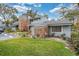 Two-story gray townhome featuring brick accents, a green lawn, and ample parking at 716 Saint Matthew Cir, Altamonte Springs, FL 32714