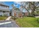 Inviting gray townhome featuring a lush green lawn and mature tree at 716 Saint Matthew Cir, Altamonte Springs, FL 32714