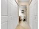 Hallway view of the bathroom includes a toilet and shelving for toiletries at 716 Saint Matthew Cir, Altamonte Springs, FL 32714