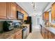 Galley kitchen featuring wood cabinets, black appliances, and recessed lighting at 716 Saint Matthew Cir, Altamonte Springs, FL 32714