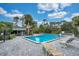 Community pool area featuring lounge chairs and a covered patio with tables and chairs at 716 Saint Matthew Cir, Altamonte Springs, FL 32714