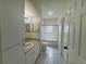 Well-lit bathroom featuring tile floors, sink with vanity, toilet, and a shower-tub combination with glass doors at 5156 City St # 118, Orlando, FL 32839