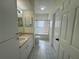 Well-lit bathroom featuring tile floors, sink with vanity, toilet, and a shower-tub combination with glass doors at 5156 City St # 118, Orlando, FL 32839