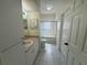 Well-lit bathroom featuring tile floors, sink with vanity, toilet, and a shower-tub combination with glass doors at 5156 City St # 118, Orlando, FL 32839