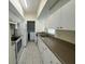 Bright kitchen featuring white cabinets, tile floors and stainless steel appliances at 5156 City St # 118, Orlando, FL 32839