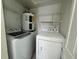Laundry room with washer, dryer, water heater and shelves at 5156 City St # 118, Orlando, FL 32839