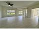 Bright living room with large windows, ceiling fan and tiled floors at 5156 City St # 118, Orlando, FL 32839