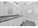 Modern bathroom with double sink vanity with granite countertop and large mirror at 8620 Caribbean Pine Way, Lakeland, FL 33809