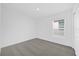 Cozy bedroom with carpet flooring and a window providing natural light at 8620 Caribbean Pine Way, Lakeland, FL 33809