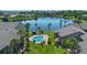 Aerial view featuring a pool and lake with multiple kayaks and lovely community landscaping at 158 Maitland Ave, Altamonte Springs, FL 32701