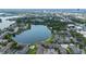 Aerial view showcasing a condo community nestled beside a serene lake with community pools at 158 Maitland Ave, Altamonte Springs, FL 32701
