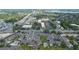 Aerial view of lakeside condos near retail areas, featuring community pools and roadways at 158 Maitland Ave, Altamonte Springs, FL 32701