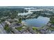 Aerial view displays a lakefront condo community surrounded by lush greenery and serene lakes at 158 Maitland Ave, Altamonte Springs, FL 32701