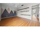 Bedroom featuring laminate floors, ceiling fan, mountain mural and custom shelves at 158 Maitland Ave, Altamonte Springs, FL 32701