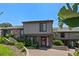 Charming townhouse featuring beautiful landscaping, a brick-paved driveway, and a neatly designed exterior at 158 Maitland Ave, Altamonte Springs, FL 32701