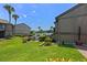 Well-maintained exterior with green lawn leading to a fenced pool area and scenic lake views at 158 Maitland Ave, Altamonte Springs, FL 32701