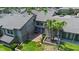 Back exterior of townhome featuring a well-kept brick patio, palm trees, and lush green lawn space at 158 Maitland Ave, Altamonte Springs, FL 32701