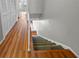Hallway featuring laminate floors and carpeted stairs at 158 Maitland Ave, Altamonte Springs, FL 32701