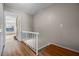 Hallway featuring wood floors, a staircase, and an entry to a bright room with large windows at 158 Maitland Ave, Altamonte Springs, FL 32701