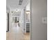 Bright, tiled hallway leading to an open living space and bathroom, showcasing the interior layout at 158 Maitland Ave, Altamonte Springs, FL 32701