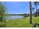 Scenic lake view with lush green lawn and a small boat near the water's edge at 158 Maitland Ave, Altamonte Springs, FL 32701