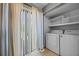 Bright laundry room with washer, dryer, tiled floors and access to backyard at 158 Maitland Ave, Altamonte Springs, FL 32701