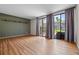 Open living room featuring wood floors and sliding glass doors leading to the backyard at 158 Maitland Ave, Altamonte Springs, FL 32701