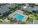 Aerial view of a community pool area with lounge chairs, tables, and lush green surroundings at 158 Maitland Ave, Altamonte Springs, FL 32701