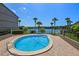 Beautiful community pool area, surrounded by palm trees, overlooking the lake, and features brick-paved lounging space at 158 Maitland Ave, Altamonte Springs, FL 32701