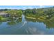 Picturesque view of a boat sailing on a tranquil waterway surrounded by lush greenery and homes at 158 Maitland Ave, Altamonte Springs, FL 32701