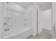 Bright bathroom showcasing a clean white tub and shower combo with tile surround at 8377 Wilder Pines Ave, Lakeland, FL 33809