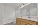 Bright bathroom with a double sink vanity, toilet, and a large mirror above the counter at 8377 Wilder Pines Ave, Lakeland, FL 33809