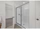 Bathroom shower with glass doors, a shower head, and tile surround at 8377 Wilder Pines Ave, Lakeland, FL 33809