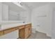 Bathroom with a large mirror above the vanity, toilet, and a towel rack at 8377 Wilder Pines Ave, Lakeland, FL 33809
