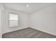Cozy bedroom with neutral carpet, a window with blinds, and freshly painted walls at 8377 Wilder Pines Ave, Lakeland, FL 33809