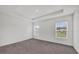 Primary bedroom featuring two large windows, gray carpet flooring and neutral paint at 8377 Wilder Pines Ave, Lakeland, FL 33809
