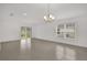 Dining area with tile flooring, chandelier lighting, and glass sliding door to the backyard at 8377 Wilder Pines Ave, Lakeland, FL 33809