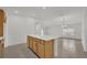 Island kitchen opens to dining area with tile flooring and warm wood-grain cabinets at 8377 Wilder Pines Ave, Lakeland, FL 33809
