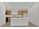 Modern kitchen featuring stainless steel appliances, white countertop island, and bright recessed lighting at 8377 Wilder Pines Ave, Lakeland, FL 33809