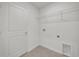 Laundry room featuring tile floors, door, and wire rack for extra storage at 8377 Wilder Pines Ave, Lakeland, FL 33809