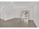 Empty living room with tile flooring and a glass sliding door to the backyard at 8377 Wilder Pines Ave, Lakeland, FL 33809