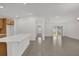 Open living area with tile flooring and a kitchen view towards the back patio entrance at 8377 Wilder Pines Ave, Lakeland, FL 33809