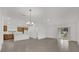 Open floorplan with living, kitchen and dining area with gray tile floors and neutral paint at 8377 Wilder Pines Ave, Lakeland, FL 33809