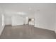 Open living area with a kitchen, dining area and a white painted walls with gray tile floors at 8377 Wilder Pines Ave, Lakeland, FL 33809