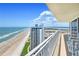 Enjoy ocean views from the balcony of this modern condominium with white railings and patio furniture at 2545 S Atlantic Ave # 2107-2108, Daytona Beach Shores, FL 32118