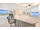 Wet bar with mirrored backsplash, granite counters, seating, and ocean view at 2545 S Atlantic Ave # 2107-2108, Daytona Beach Shores, FL 32118