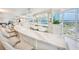 Stunning condo wet bar with white marble countertop, seating, and city views from expansive windows at 2545 S Atlantic Ave # 2107-2108, Daytona Beach Shores, FL 32118