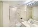Clean bathroom featuring a glass shower, white tiling, and a vanity with ample counter space at 2545 S Atlantic Ave # 2107-2108, Daytona Beach Shores, FL 32118